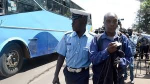 A police officer inspecting a PSV matatu